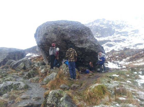 taking shelter under a giant rock